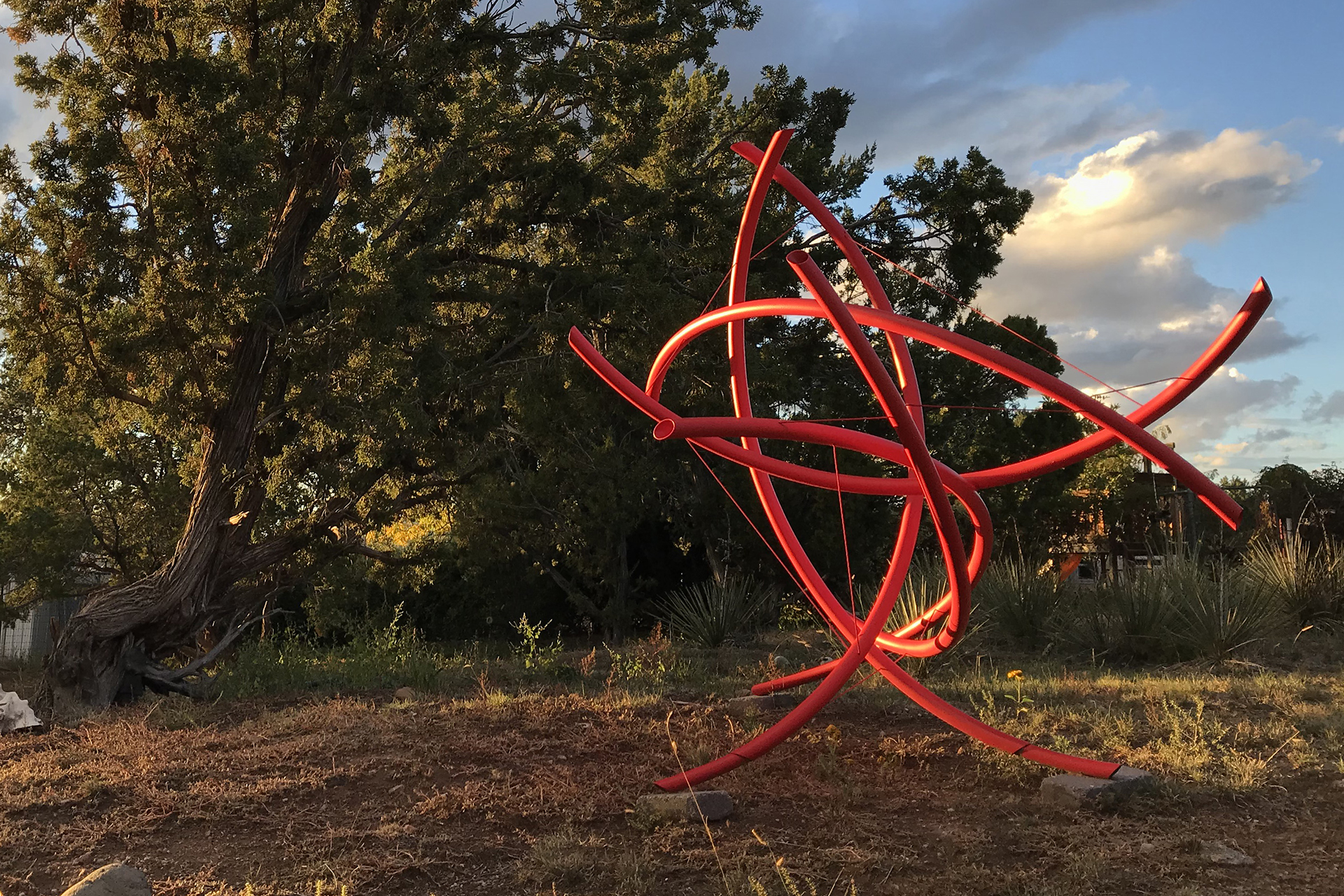 Outdoor tension sculpture.  Rolled steel tubing with painted finish.